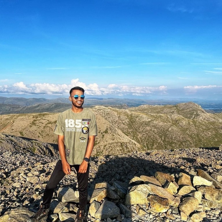 Young man poses on the highest point in England