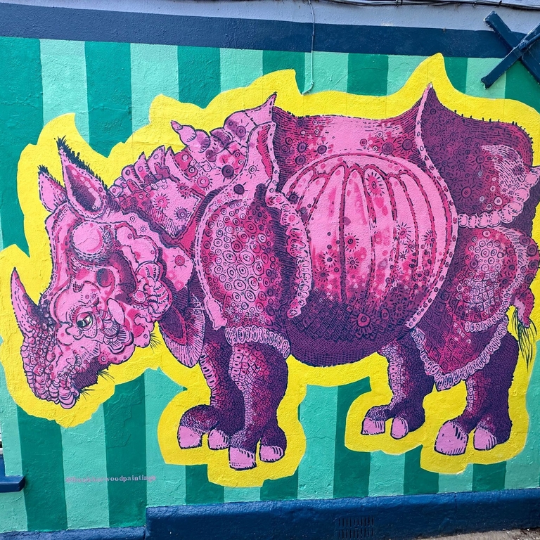 Street art showing a pink rhino