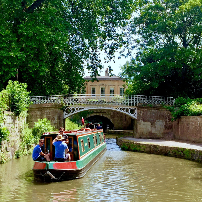 A barge sailing down a canal in Bath