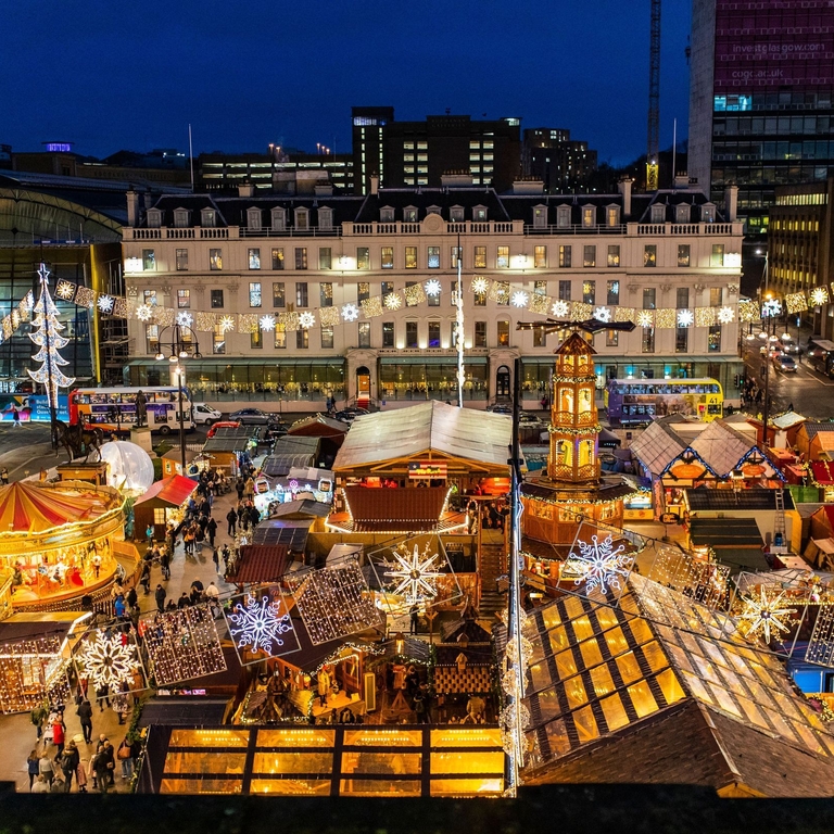 Aerial view of christmas market and funfair lit up at night