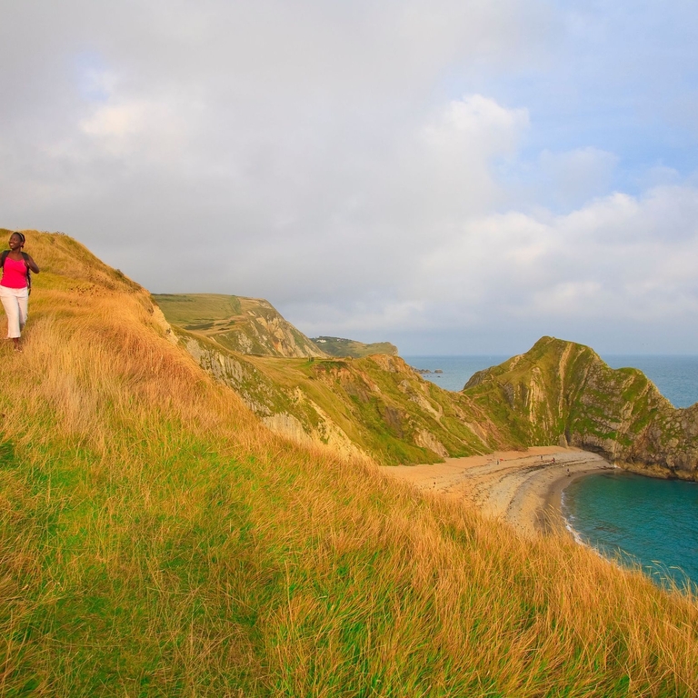 A couple walking on the clifftop.