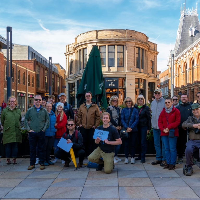 A walking tour group posing in Lincoln's city centre