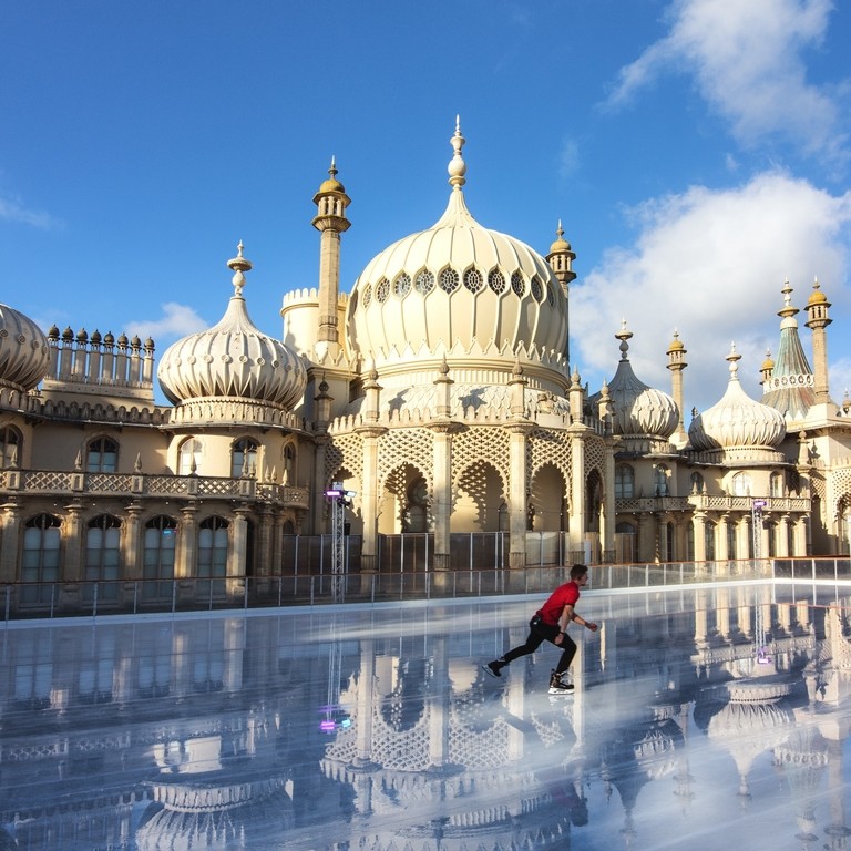 Ice skater with red t-shirt on rink outside Royal Pavilion