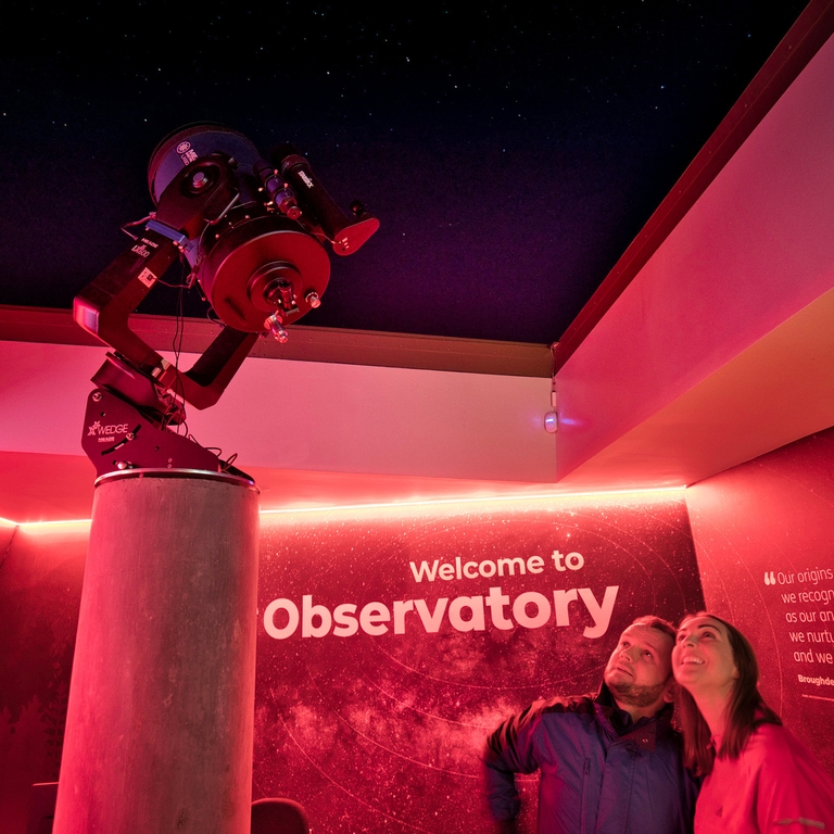 Two people at Dark Sky Park and Observatory looking at Mead Telescope
