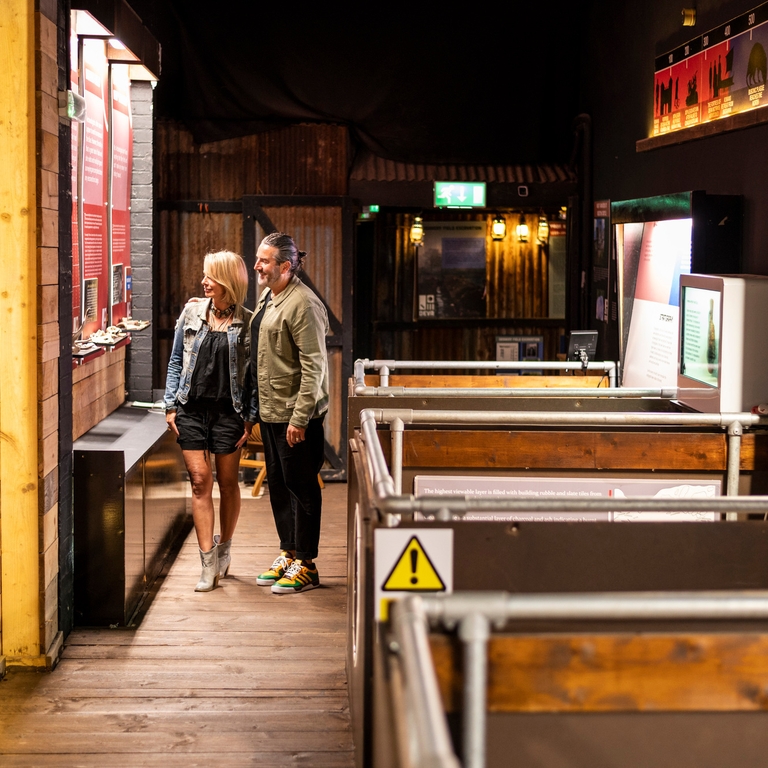 Two people looking at exhibits at the Deva Roman Experience in Chester