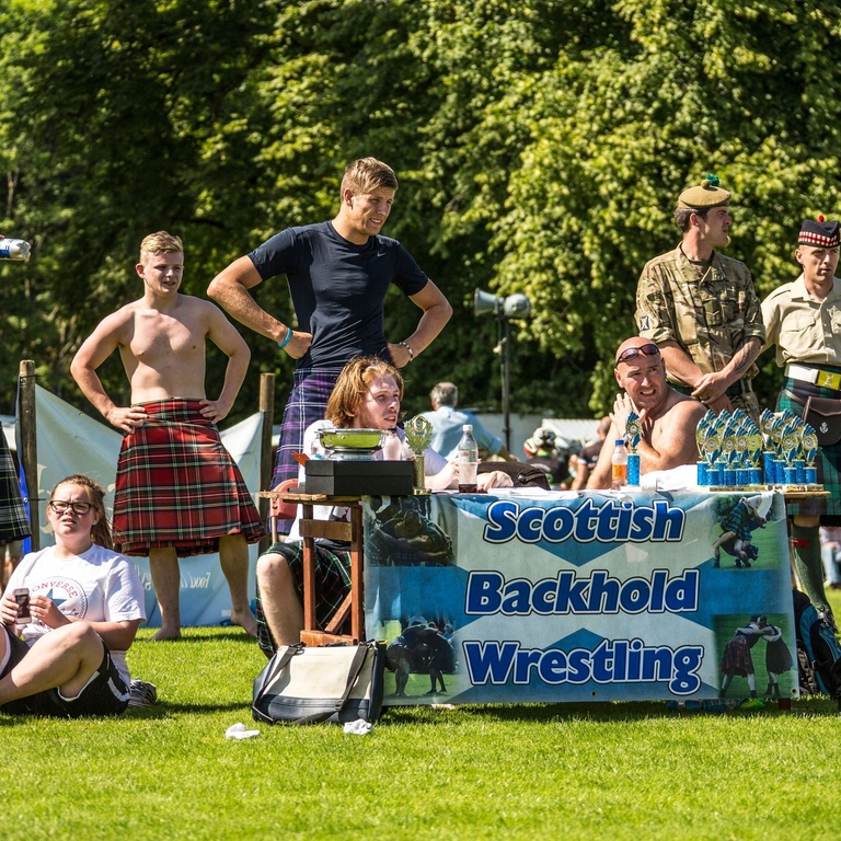 Inveraray Argyll Highland Games at Inveraray Castle. Group of men wearing kilts.