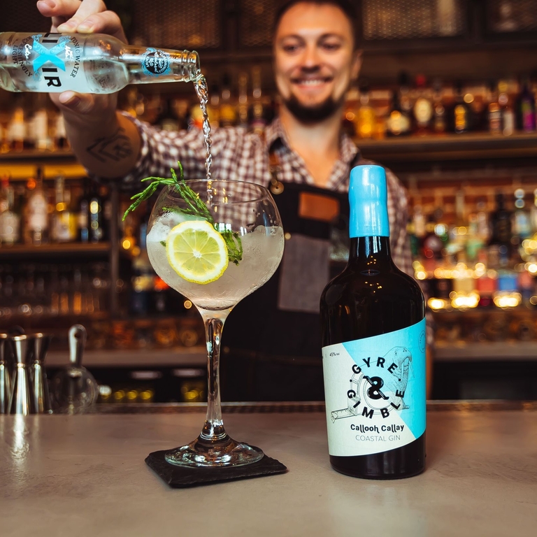 A bartender pouring a cocktail with coastal gin at Gyre & Gimble in Norwich