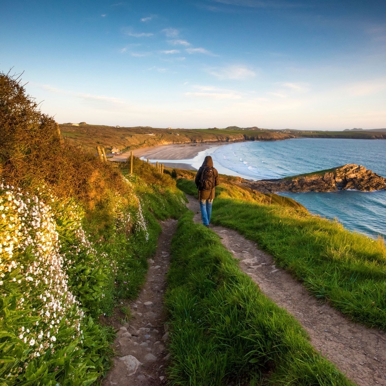 Walker on the Pembrokeshire coast path at Whitesands near St Davids, Wales