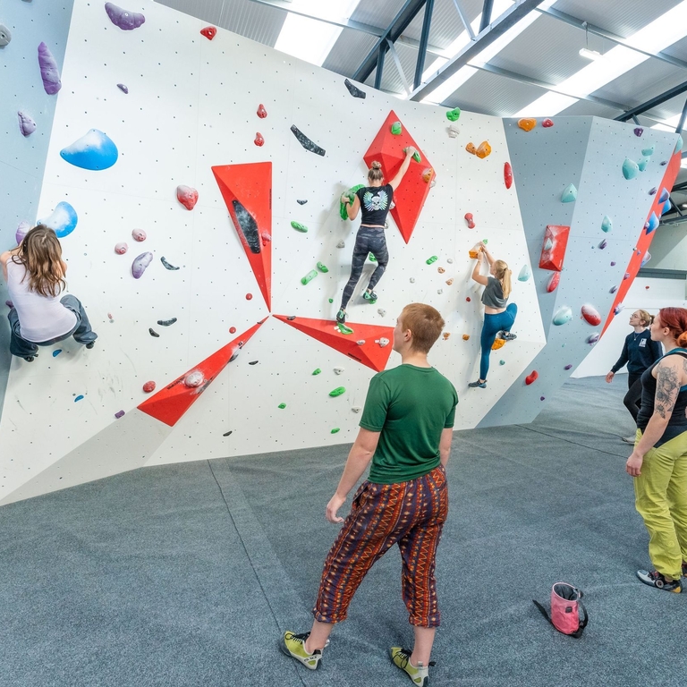 People climbing an indoor bouldering wall in Lancashire