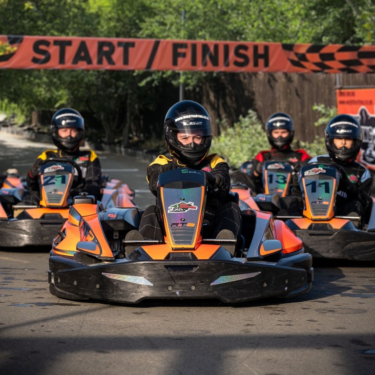 A group of people racing go-karts