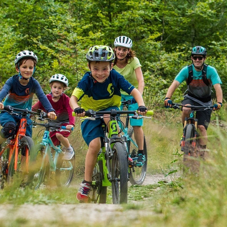 A group of children and parents cycling through the Leicestershire countryside