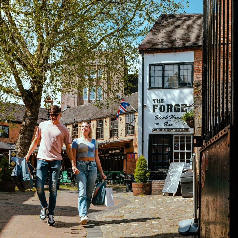 A couple walking through a courtyard