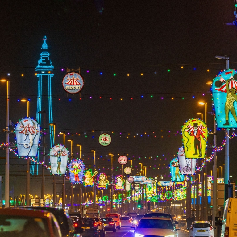 Blackpool Illuminations lighting up a road at night.