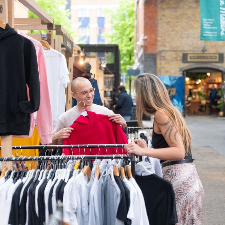 Two people at a market stand at Old Spitafields Market