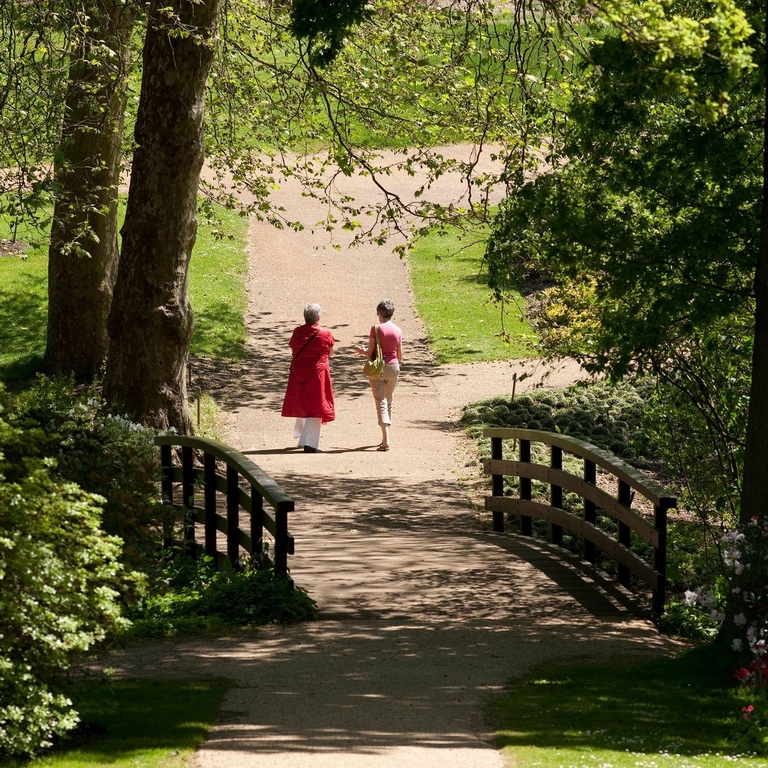 Two women walking through the Savill Garden in Windsor
