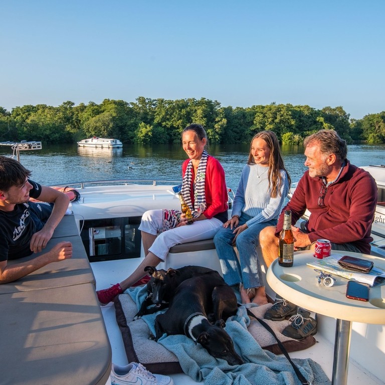 A family relaxing on a boat in the Broads