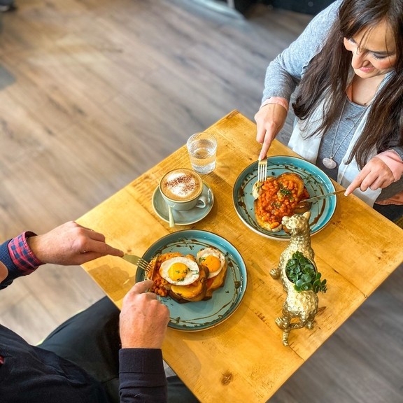 People enjoying food at a table in the Vibe Cafe in Liverpool