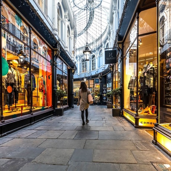 People walking between shops, lit up from inside