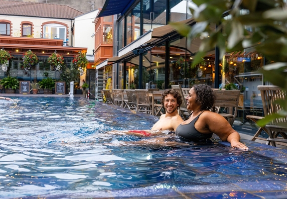 Man and woman relaxing in an outdoor swimming pool