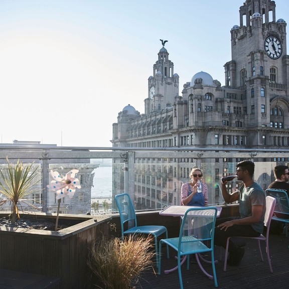 Rooftop terrace restaurant with expansive city views.
