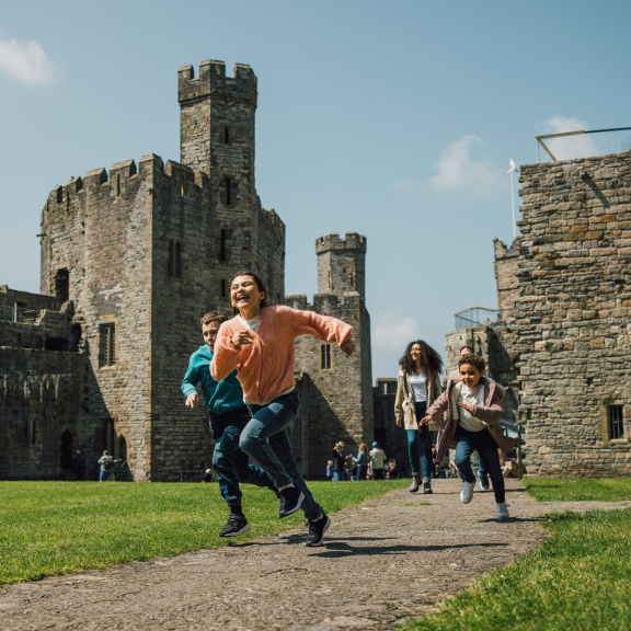 Kids running through the grounds of an old castle.
