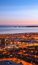 An overhead shot of Swansea town and seaside at dusk.