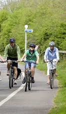 A group of people cycling along a path in Bristol