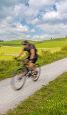 View of cyclist on the Tissington Trail, Tissington, Peak District National Park, Derbyshire, England, United Kingdom, Europe