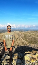 Young man poses on the highest point in England