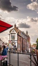 People sitting at tables outside on Norwich Lanes