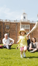 Children and parents sitting on the fields around Temple Newsam in Leeds