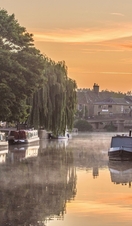 Canal boats moored along the River Great Ouse in Ely