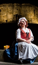 A performer in costume outside Cliffords Tower in York