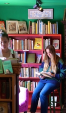 People browsing through shelves of books at Much Ado Books