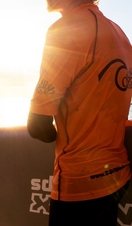 A man holding a surfboard on a beach in Cornwall