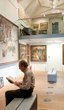 A man reading a book in the Stanley Spencer Gallery in Windsor