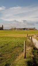 Woman walking along path between Whitby and Robin Hood's Bay.