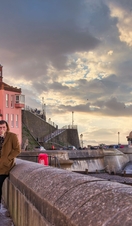 Groups of people stood on the promenade looking out on Cromer Beach