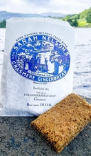 Closeup of Grasmere Gingerbread on a rock by a lakeside