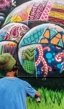 An artist with a can working on artwork. Cartoon design