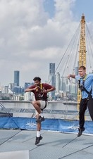 Three people jumping on the roof of the O2 Arena