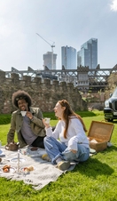 People having a picnic as part of a taxi tour in Manchester