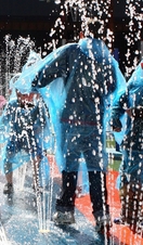 Groups of children running through a water feature at the Magna Science Adventure Centre