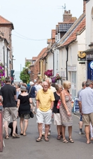 People walking through a shopping street in Wells-next-the-Sea