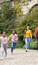 A family exploring the grounds of the Bowes Museum