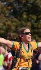 A woman celebrating while crossing the finish line on a run in Newcastle
