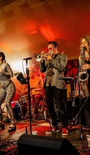 A brass band performing on stage at Unearthed Festival in Wales