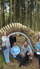 A group of people posing next to a sculpture on the Pendle Sculpture Trail