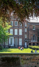 People relaxing in the grounds in from of Hollytrees Museum