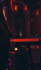 A DJ setting up on stage at a nightclub venue